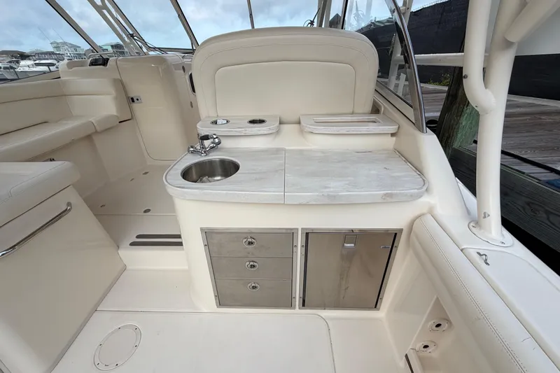 Slide: The Image of 2018 Grady-White Freedom 335 boat interior with sink and storage cabinets. - 28