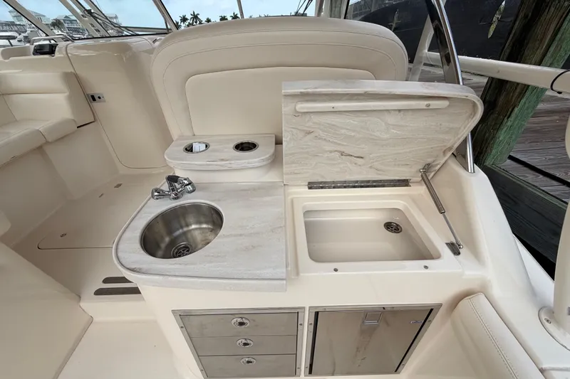 Slide: The Image of 2018 Grady-White Freedom 335 boat interior with sink and storage area. - 29