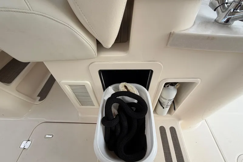 Slide: The Image of 2018 Grady-White Freedom 335 boat interior with storage compartment and fire extinguisher. - 32