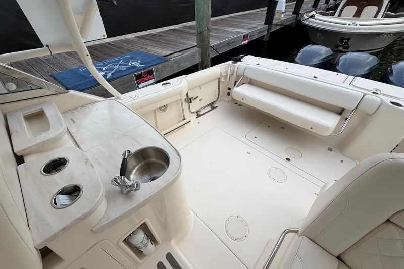Slide: The Image of 2018 Grady-White Freedom 335 boat interior with sink and seating area. - 33