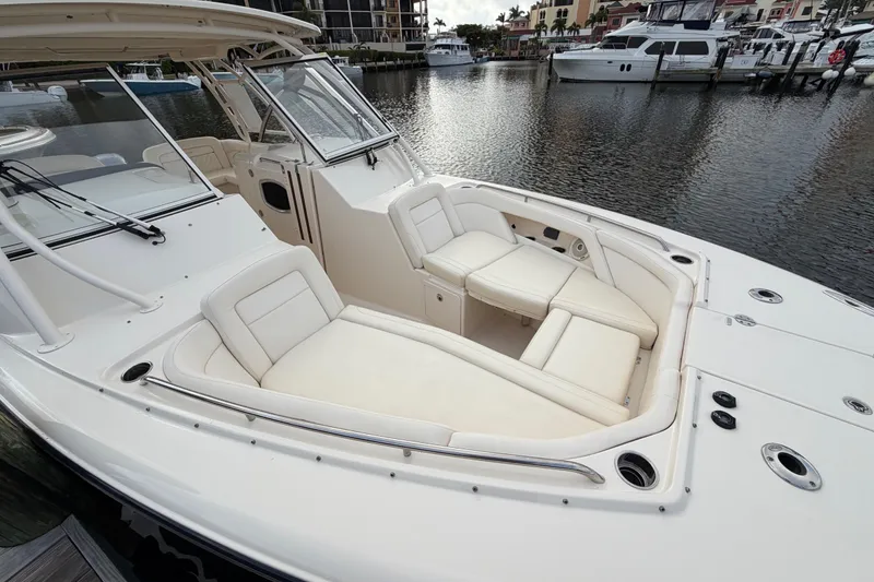 Slide: The Image of 2018 Grady-White Freedom 335 boat with spacious seating in a marina setting. - 34