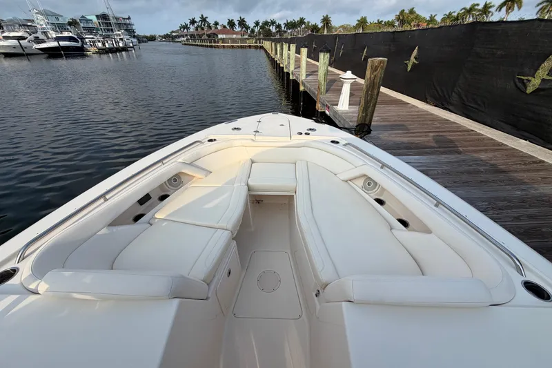 Slide: The Image of 2018 Grady-White Freedom 335 boat with spacious seating at a marina dock. - 36