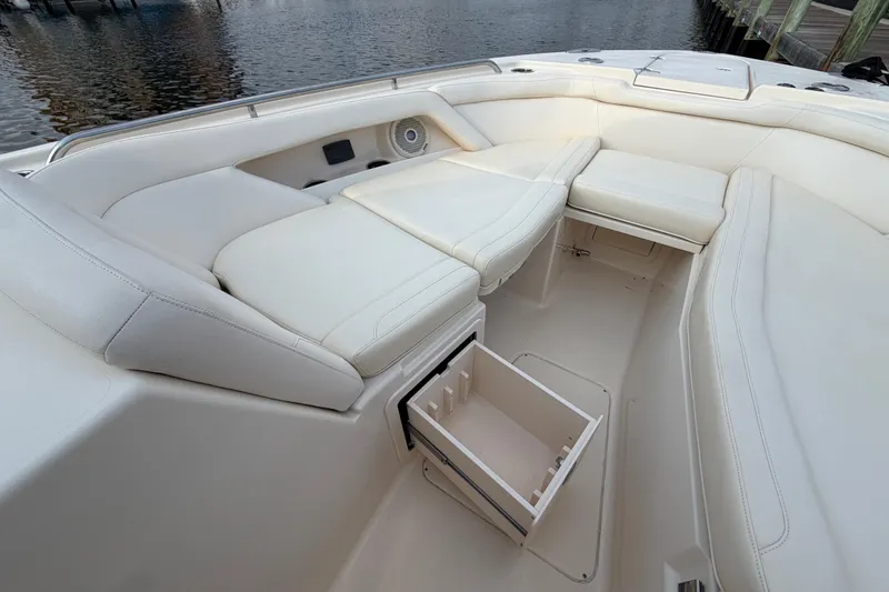 Slide: The Image of 2018 Grady-White Freedom 335 boat interior with white seating and storage compartment. - 39