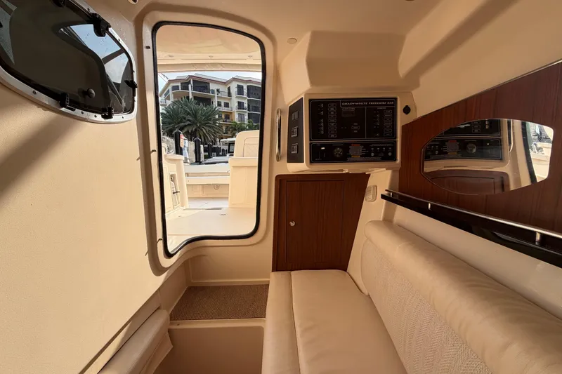 Slide: The Image of 2018 Grady-White Freedom 335 cabin interior with plush seating and wood accents. - 41