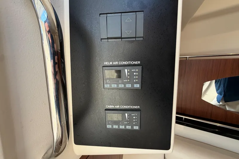 Slide: The Image of Control panel of a 2018 Grady-White Freedom 335 boat, showing AC and DC switches. - 44