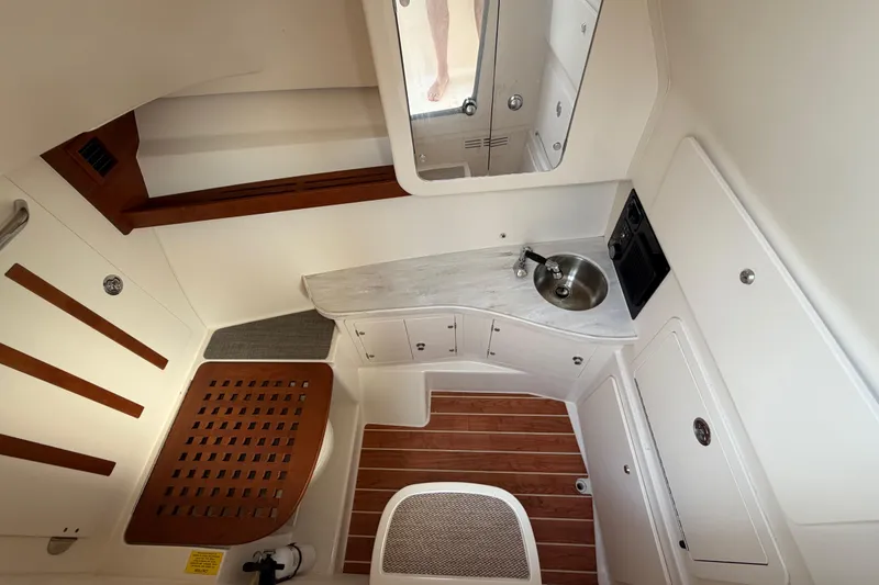 Slide: The Image of 2018 Grady-White Freedom 335 interior with Fusion stereo system and wooden cabinetry. - 46