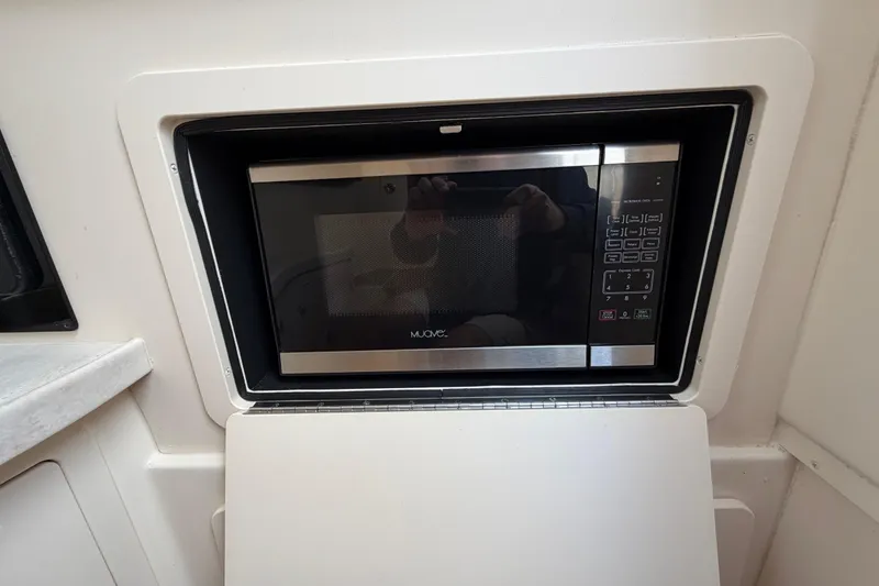 Slide: The Image of 2018 Grady-White Freedom 335 cabin interior with wooden accents and safety equipment. - 49