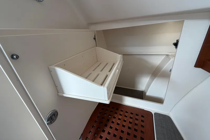 Slide: The Image of 2018 Grady-White Freedom 335 interior storage compartment with wooden flooring. - 52