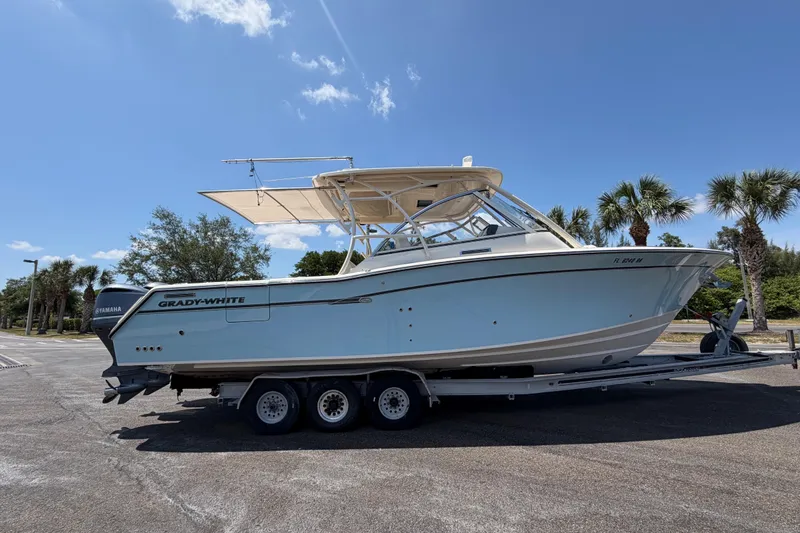 Slide: The Image of 2018 Grady-White Freedom 335 boat on trailer under clear blue sky. - 8