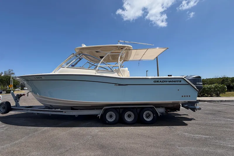 Slide: The Image of 2018 Grady-White Freedom 335 boat on trailer under clear blue sky. - 9