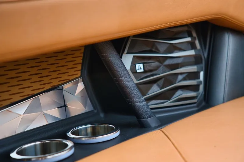 Slide: The Image of Interior details of 2022 Nautique Super Air Nautique G23 with speaker and cup holders. - 21