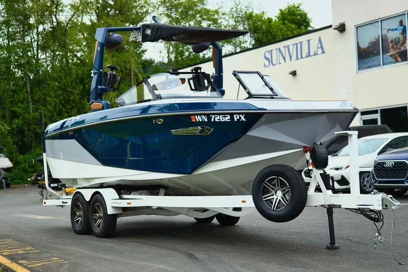 Slide: The Image of 2022 Nautique Super Air Nautique G23 on trailer in front of Sunvilla. - 3