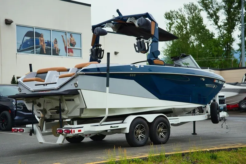 Slide: The Image of 2022 Nautique Super Air Nautique G23 on trailer, blue and white design. - 5