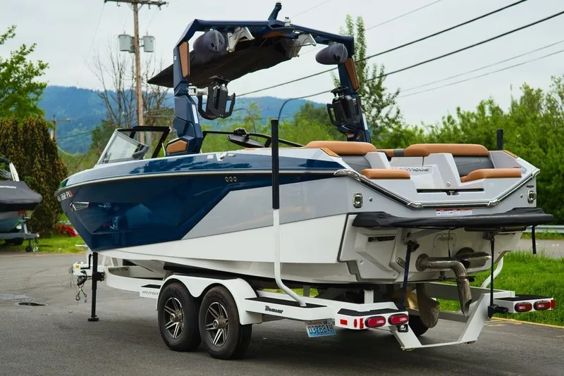 Slide: The Image of 2022 Nautique Super Air Nautique G23 on trailer, blue and white design. - 7