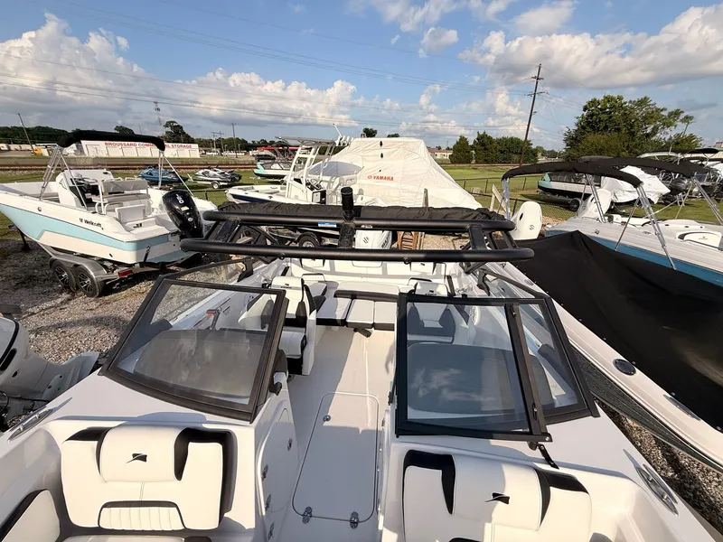 Slide: The Image of 2026 Stingray 20 SBX boat parked outdoors under sunny skies. - 19