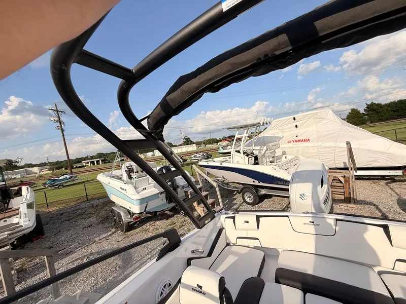 Slide: The Image of 2026 Stingray 20 SBX boat in a lot with other boats. - 23