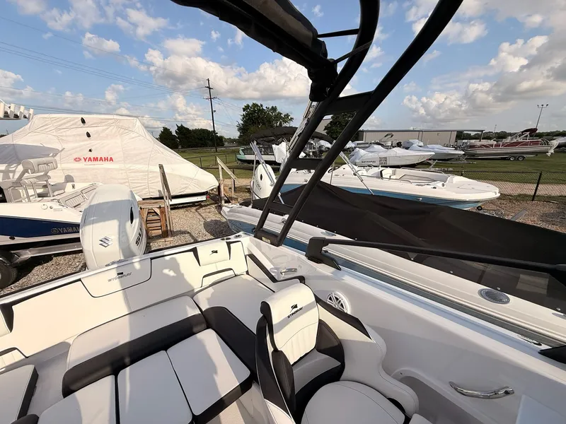 Slide: The Image of 2026 Stingray 20 SBX boat outdoors under sunny skies. - 24