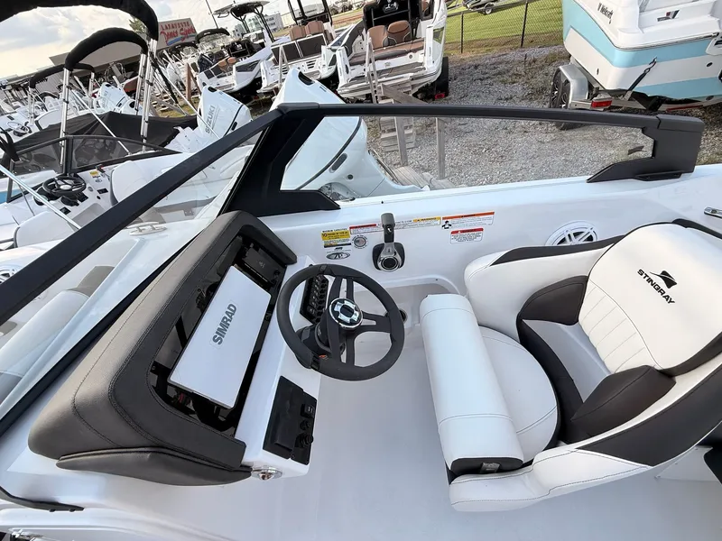 Slide: The Image of Interior of a 2026 Stingray 20 SBX boat with steering and seat. - 26