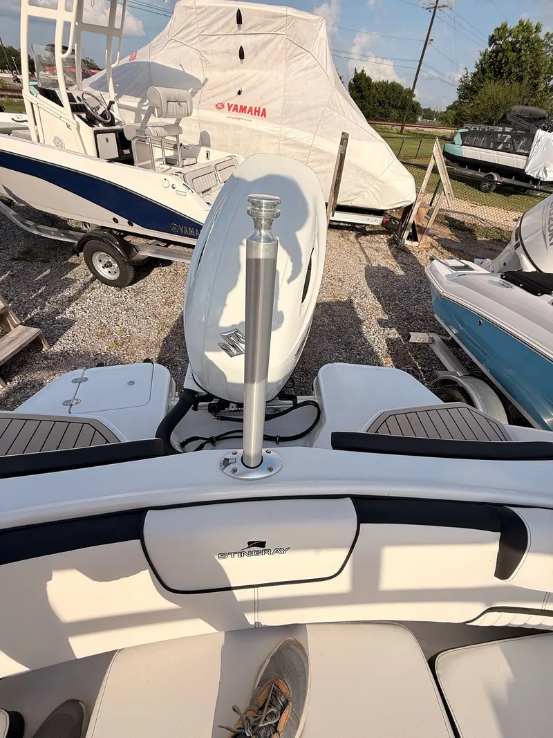 Slide: The Image of Stingray 20 SBX 2026 boat outdoors with motor view. - 38