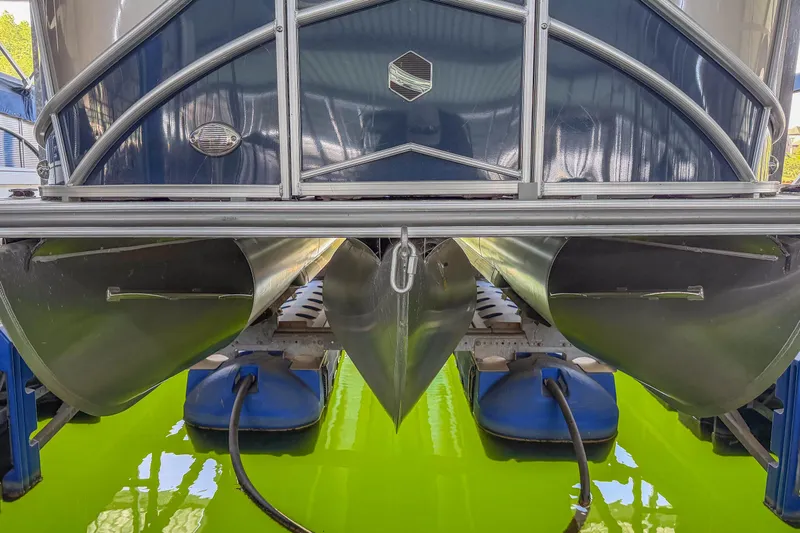 Slide: The Image of 2017 South Bay 523 RS pontoon boat on vibrant green water, showcasing pontoons and structure. - 15