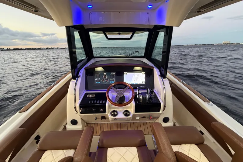 Slide: The Image of 2021 Chris-Craft Catalina 34 helm with modern controls, overlooking serene ocean waters. - 12