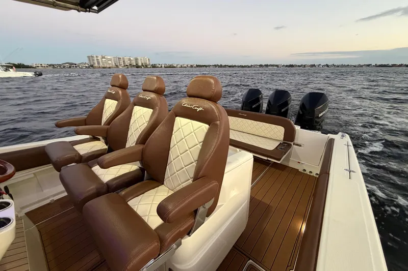Slide: The Image of 2021 Chris-Craft Catalina 34 boat interior with luxurious seating and powerful engines on open water. - 15