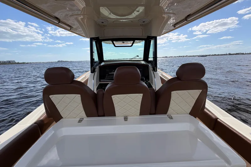 Slide: The Image of 2021 Chris-Craft Catalina 34 boat interior with luxurious seating on open water. - 16