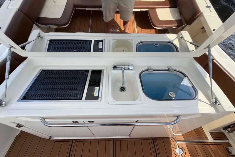 Slide: The Image of 2021 Chris-Craft Catalina 34 boat interior with sink, grill, and seating area. - 19