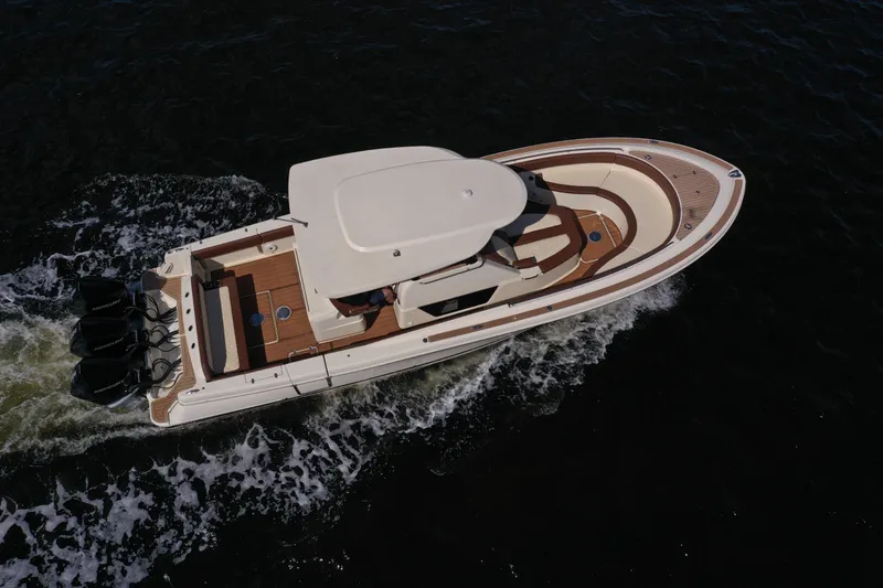 Slide: The Image of 2021 Chris-Craft Catalina 34 cruising on water, aerial view. - 2