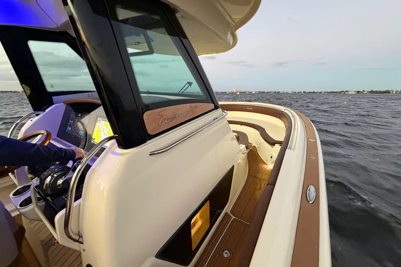 Slide: The Image of 2021 Chris-Craft Catalina 34 boat cruising on open water at sunset. - 28
