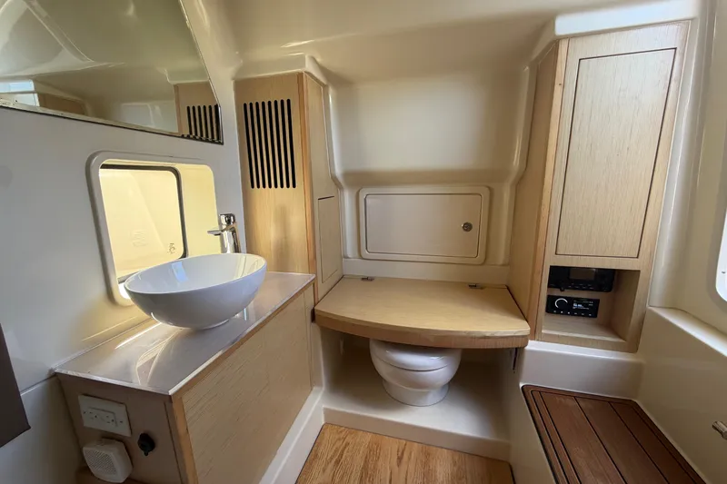 Slide: The Image of 2021 Chris-Craft Catalina 34 bathroom with modern sink, toilet, and wooden cabinetry. - 38