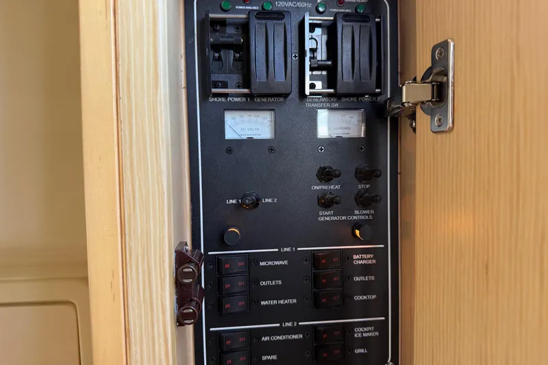 Slide: The Image of Electrical panel inside 2021 Chris-Craft Catalina 34 boat, featuring various power controls and switches. - 41
