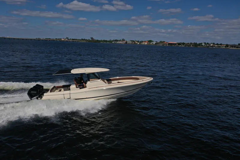 Slide: The Image of 2021 Chris-Craft Catalina 34 cruising on open water under a clear blue sky. - 7