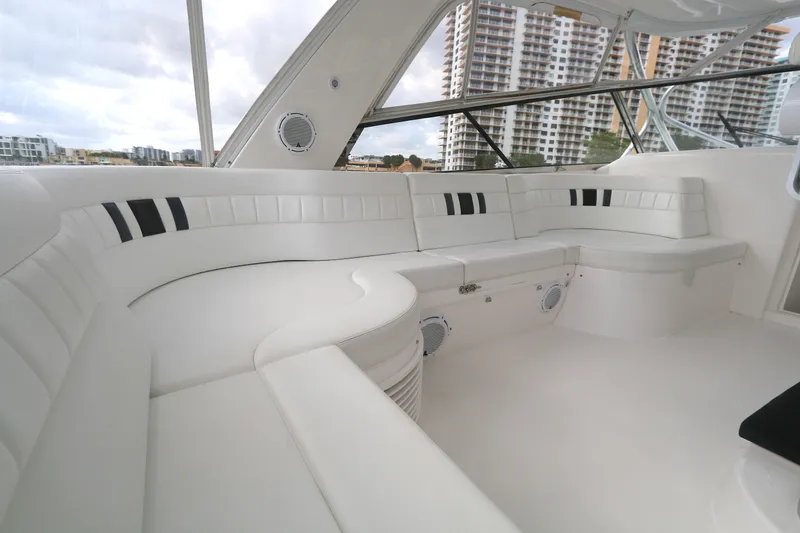 Slide: The Image of Luxurious white seating area on a 2012 Intrepid 475 Sport Yacht, with cityscape view. - 1
