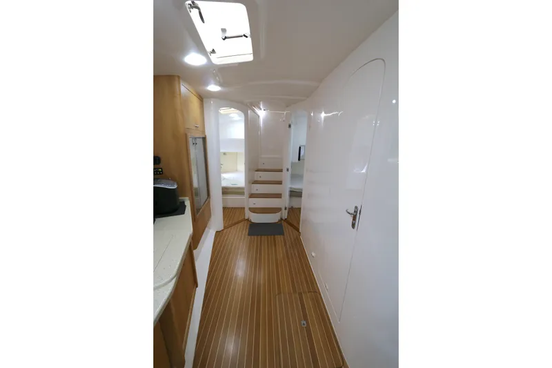 Slide: The Image of Interior of 2012 Intrepid 475 Sport Yacht with sleek design and wooden flooring. - 10