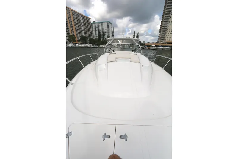 Slide: The Image of 2012 Intrepid 475 Sport Yacht on water, cityscape background, cloudy sky. - 13