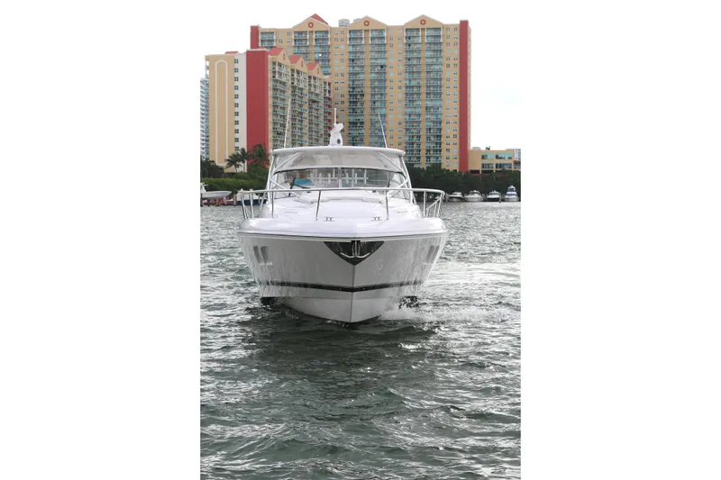Slide: The Image of 2012 Intrepid 475 Sport Yacht cruising in urban waterfront setting. - 21