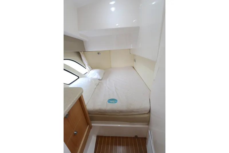 Slide: The Image of Cozy cabin interior of 2012 Intrepid 475 Sport Yacht with bed and wooden cabinetry. - 7