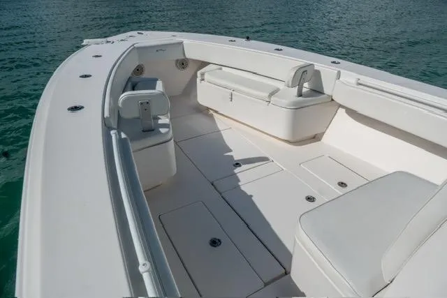 Slide: The Image of 2019 Contender 32 ST boat interior with seating and storage, on calm water. - 18
