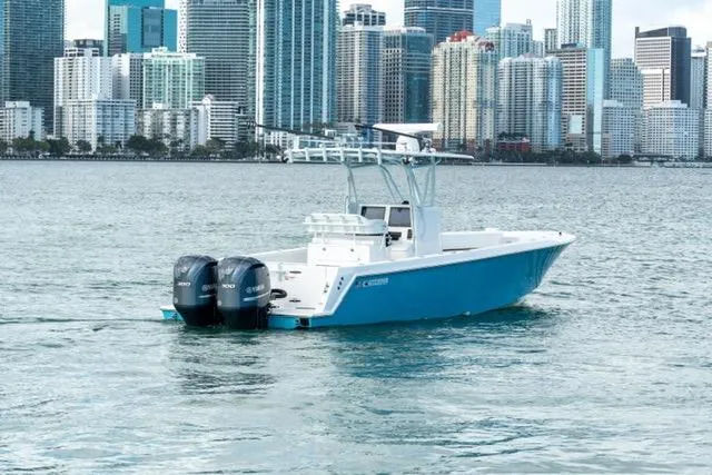 Slide: The Image of 2019 Contender 32 ST boat on water with city skyline in background. - 2