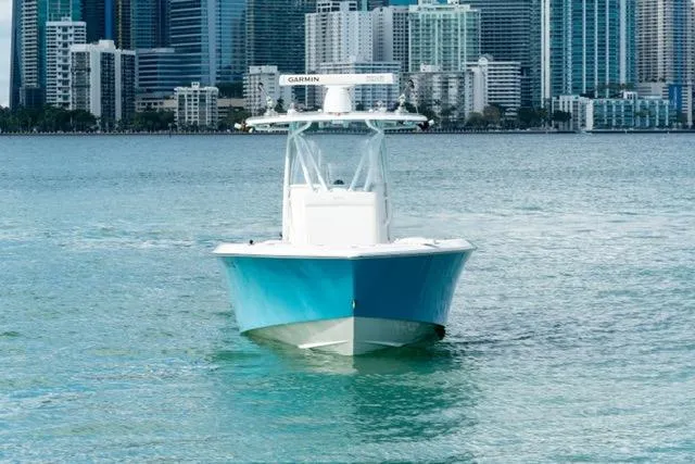 Slide: The Image of 2019 Contender 32 ST boat on water with city skyline backdrop. - 4
