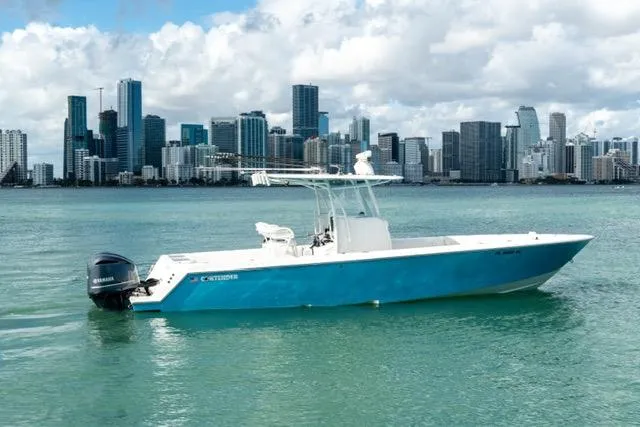 Slide: The Image of 2019 Contender 32 ST boat on water with city skyline in background. - 5