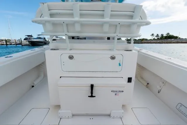 Slide: The Image of 2019 Contender 32 ST boat interior with storage compartments, docked near a marina. - 7