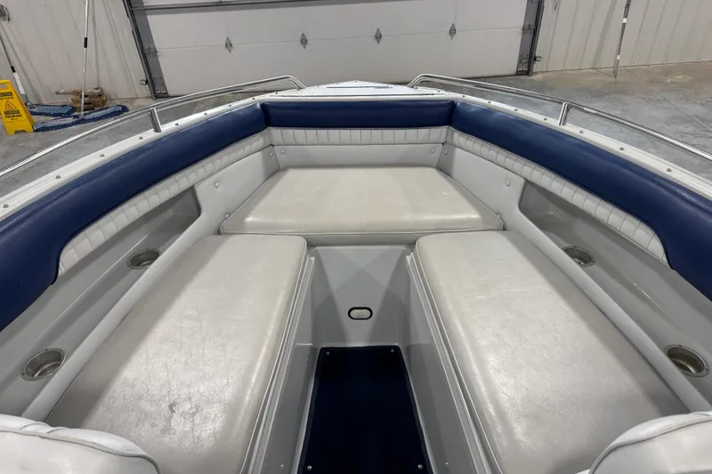 Slide: The Image of Interior of a 1998 Mariah 272 Shabah boat with white and blue seating. - 11