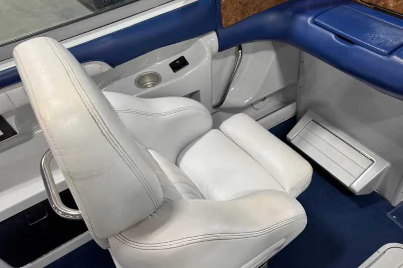 Slide: The Image of Interior of a 1998 Mariah 272 Shabah boat with white and blue seating. - 12
