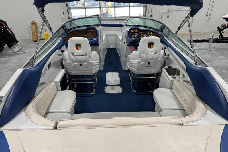 Slide: The Image of Interior of a 1998 Mariah 272 Shabah boat with blue and white seating. - 14