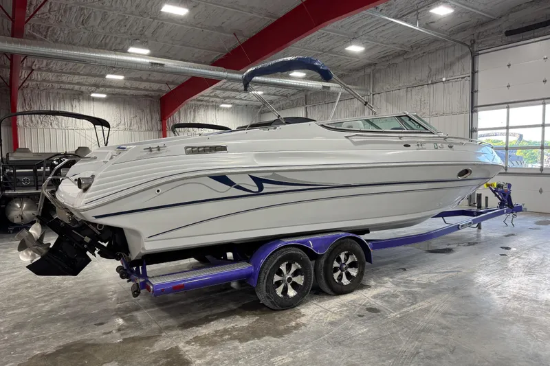 Slide: The Image of 1998 Mariah 272 Shabah boat on trailer in indoor storage facility. - 5
