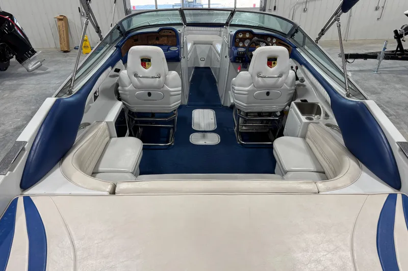 Slide: The Image of Interior of a 1998 Mariah 272 Shabah boat with blue and white seating. - 6