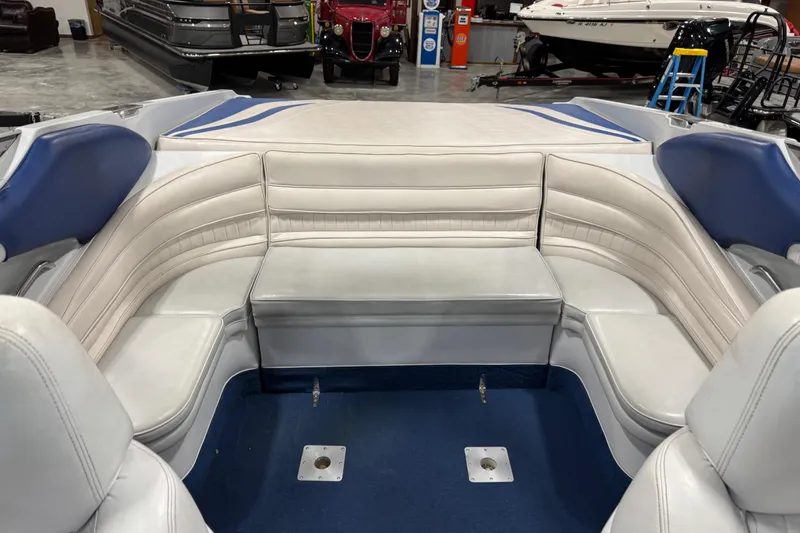 Slide: The Image of Interior of a 1998 Mariah 272 Shabah boat with white and blue seating. - 9