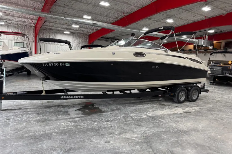 The Image of 2010 Sea Ray 280 Sundeck boat on trailer in indoor storage facility. - 1